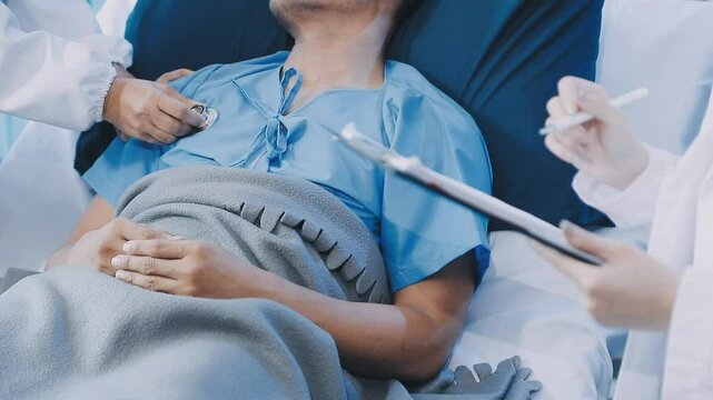 A doctor examining a middle-aged male patient in a coma in a hospital bed