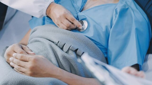A doctor examining a middle-aged male patient in a coma in a hospital bed