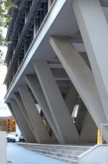 Concrete angled pylons holding up a the building. Angled columns