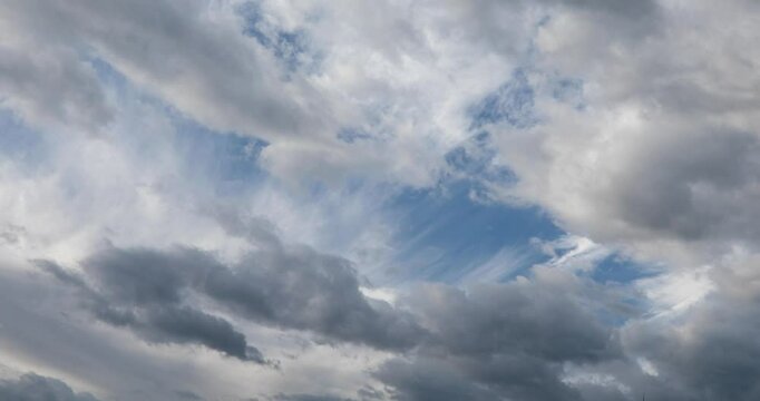 Two direction moving clouds on two layers in the cold morning autumn sky. 