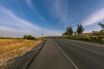 A road with a clear blue sky above it