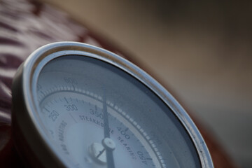 Pointer showing temperature on thermometer on a barbecue