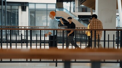 Multicultural hipster group walking while dancing at modern corridor. Attractive break dance team happy and joy while moving to hip-hop music. Active. Site view. Outdoor sport 2024. Hiphop.