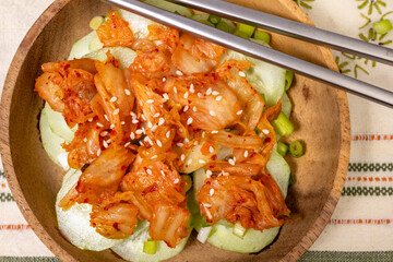 Wooden bowl with a Kimchi and Cucumber salad