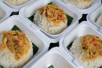 Boxed rice. Rows of packaged rice boxes, spicy seasoned shredded chicken.
