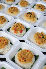 Boxed rice. Rows of packaged rice boxes, spicy seasoned shredded chicken.