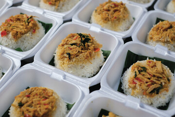 Boxed rice. Rows of packaged rice boxes, spicy seasoned shredded chicken.