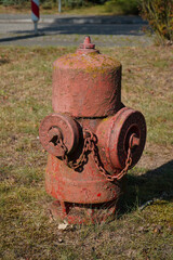 Red orange colored old hydrant to protect the inhabitants in case of fire in the small village...