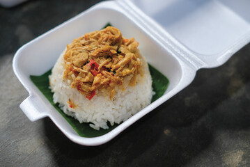 Boxed rice. Rows of packaged rice boxes, spicy seasoned shredded chicken.