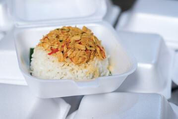 Boxed rice. Rows of packaged rice boxes, spicy seasoned shredded chicken.