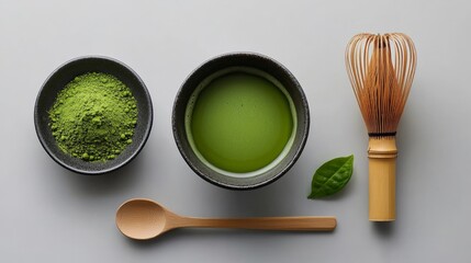 A top-down view of matcha tea preparation, with a bamboo whisk, matcha bowl, and fresh green powder beautifully arranged