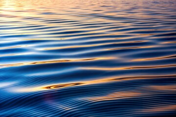 Golden ripples on water reflecting sunlight close-up