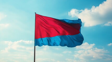
Waving Red and Blue Flag Against Blue Sky