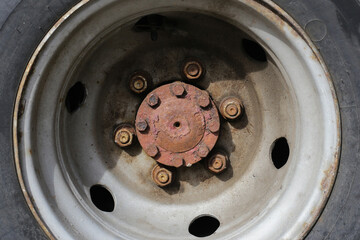 Rusty truck wheel rim and cracked tire. Grunge detail truck tyre. Transportation industry....