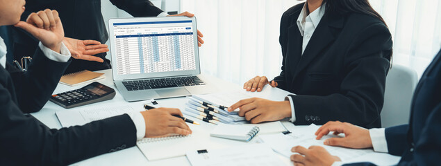 Corporate accountant team use accounting software on laptop to calculate and maximize tax refund...