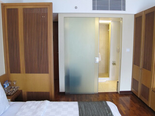 A hotel room interior with a minimalist design that offers comfort and tranquility, making it an ideal destination for a family vacation