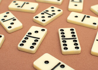 Dominoes bones on brown background	