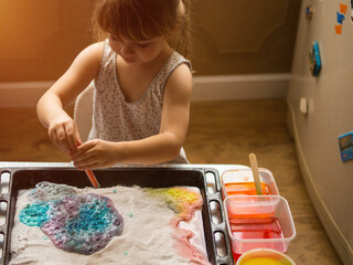 a child makes experiments with chemicals. experiments with soda and citric acid