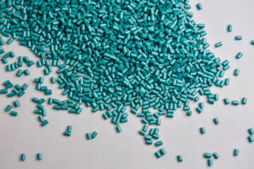 pearl turquoise masterbatch granules on a white background, this polymer is a product coloring...