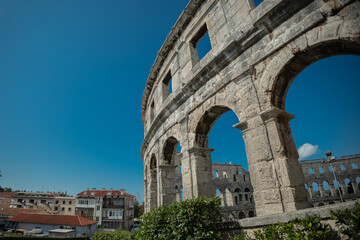 Naklejka premium Beautiful colloseum or amphitheatre iin Pula, viewed on a sunny day without clouds. Blue skies above the theatre in pula