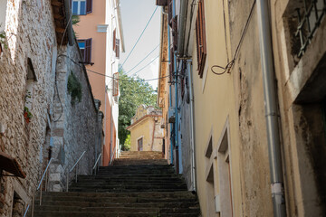 One of many narrow streets in pula, croatia full of high stairs leading to upper city and the fortress