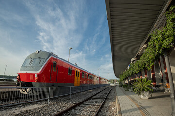 Train station in Pula, croatian coastal town. Beautiful train station with green foliage and red...
