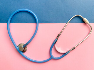 Doctor concept. Top view of stethoscope on pink and blue background with space for text or promotion