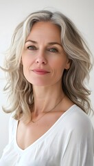 Naklejka premium Portrait of mature beautiful woman with blonde hairstyle on white background