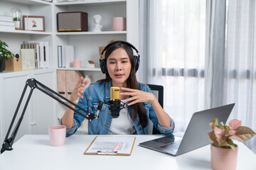 Host channel of young beautiful Asian wearing jeans creative broadcaster talking in online...