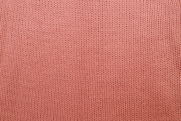 knitted fabric of dusty pink color from wool yarn. Knitting as a form of relaxation.