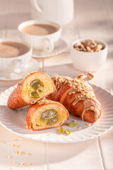 Delicious and sticky pistachio croissants served with hot coffee.