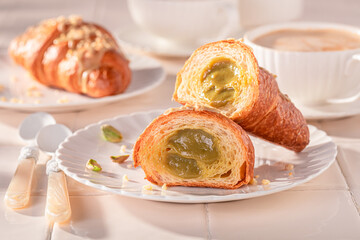 Homemade and hot pistachio croissants served with hot coffee.