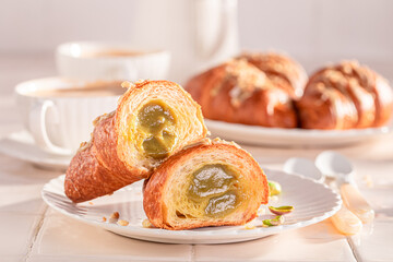Sweet and aromatic pistachio croissants with nut filling.