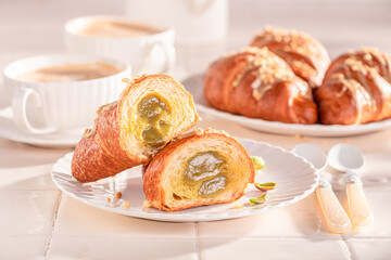 Tasty and fresh pistachio croissants with nut filling.