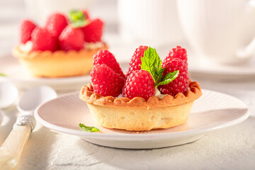 Tasty mini tart made of raspberries and cream.