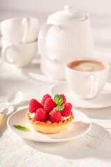 Sweet mini tart made of raspberries and cream.