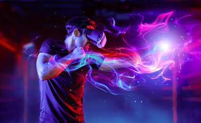 Man wearing VR glass and smashing or punching at camera in neon boxing arena. Sport gamer boxing and moving gesture in metaverse or virtual world while using digital technology innovation. Deviation.