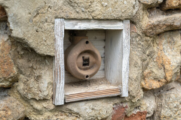 Old historic antique vintage light switch in a wooden frame from the 40s and 50s with brickwork all around