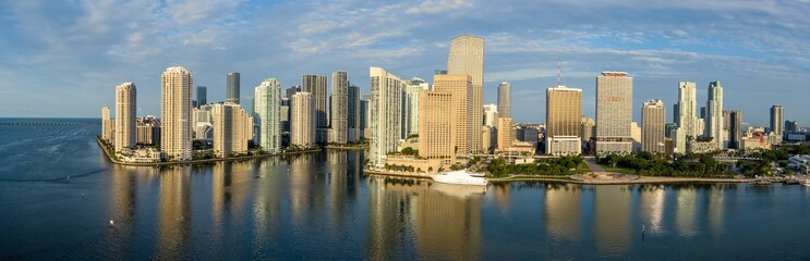 Downtown city skyline and calm ocean waterfront of Miami at sunrise, Florida, United States.