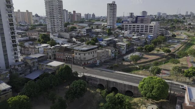 Drone flies north from Parque Senador Jefferson Peres park over bridge into Parque Igarap&eacute; de Manaus in Manaus, Amazonas, Brazil