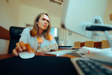 Busy Medical Doctor Working at the Computer in her Office. MD tied up in bureaucracy and paperwork feeling overwhelmed 
