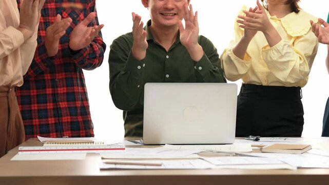 Architect and safety engineer celebrate success design building blueprint project on laptop with architectural document and measurement tool scatter around at modern office. Closeup. Delineation.