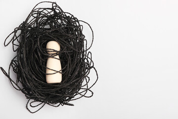 Loneliness concept. Human figure caught in net of thoughts on white background, top view. space for...