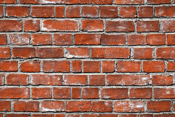 Fototapeta premium Red brick wall background with visible textures and patterns, perfect for creative projects or adding a nostalgic and timeless touch to any space.