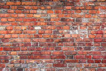 Obraz premium Red brick wall background with visible textures and patterns, perfect for creative projects or adding a nostalgic and timeless touch to any space.
