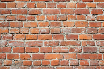 Red brick wall background with visible textures and patterns, perfect for creative projects or adding a nostalgic and timeless touch to any space.