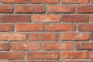 Obraz premium Red brick wall background with visible textures and patterns, perfect for creative projects or adding a nostalgic and timeless touch to any space.