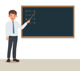 Young male teacher standing in front of class teaching math lesson at blackboard
