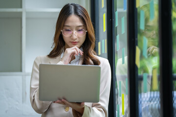 Happy Asian woman working in office