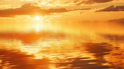 Fototapeta premium A golden sky during sunset with soft clouds and reflections on the water, creating a serene and peaceful atmosphere